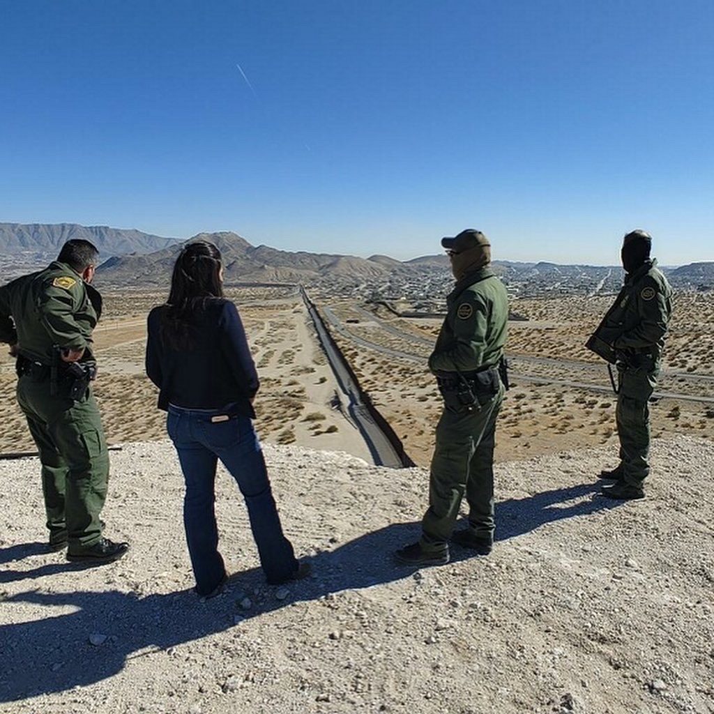 Jessica Jallings Gomez with Border Patrol agents looking out over the U.S.-Mexico border