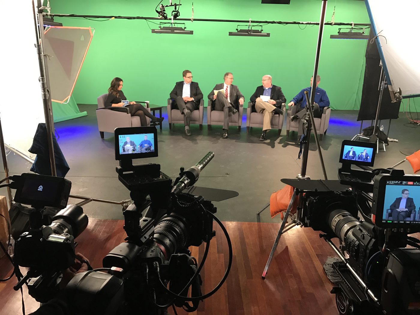 Jessica Jallings Gomez moderating a four-person panel on a studio set, seen from behind the production cameras